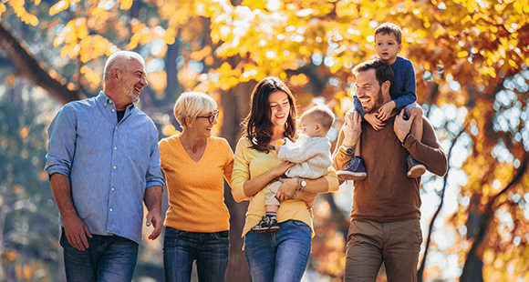 a happy family walking together in autumn with colorful leaves enjoying time together with kids and creating joyful memories