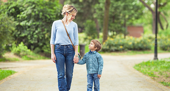 mother and child walking together in a park enjoying time outdoors and bonding moments